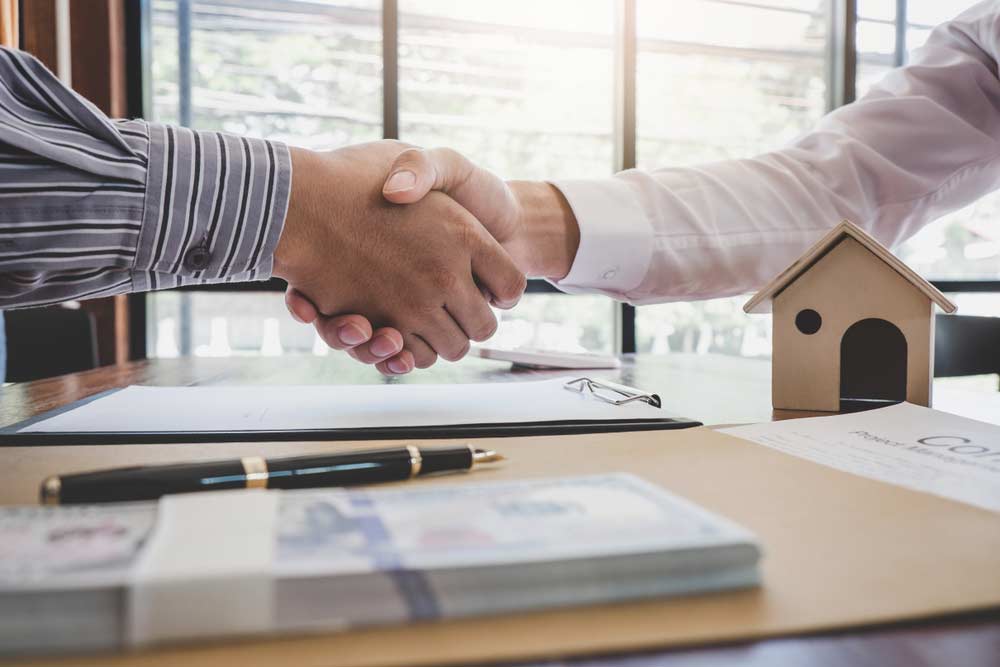 Real estate agent shaking hands with a client